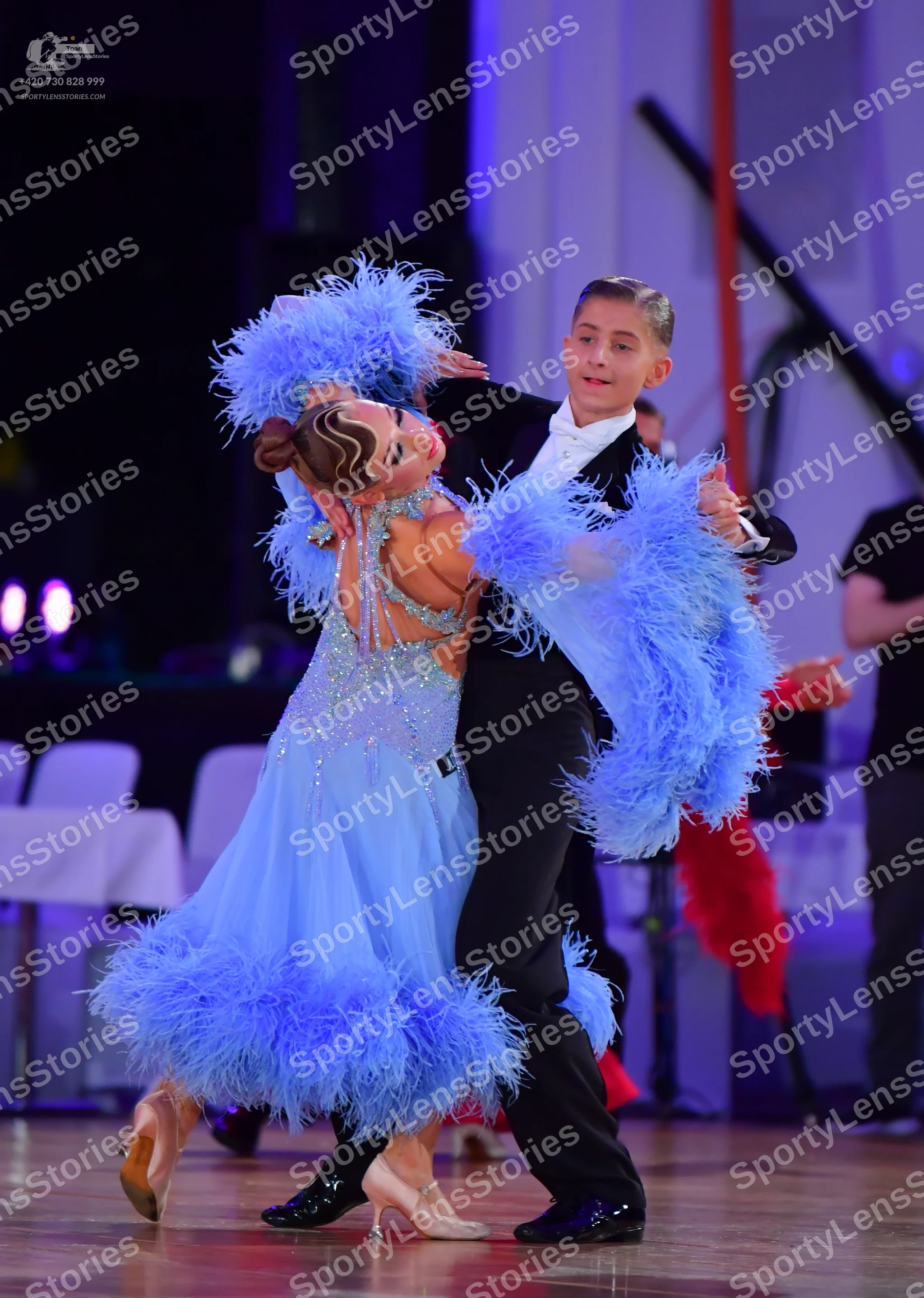Dancesport competitor: Female dancer: light blue Latin dance dress with a sequined bodice and voluminou