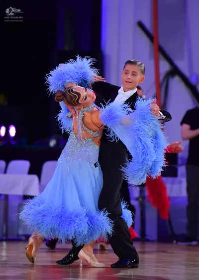 Dancesport competitor: Female dancer: light blue Latin dance dress with a sequined bodice and voluminou