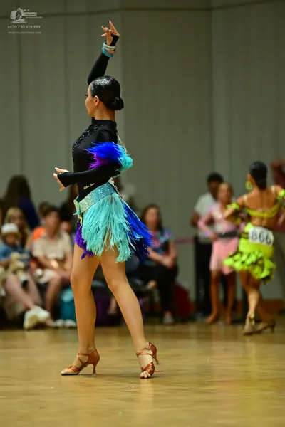 Dancesport competitor #866: Female dancer in foreground: black long-sleeved latin dress with sequins on the 