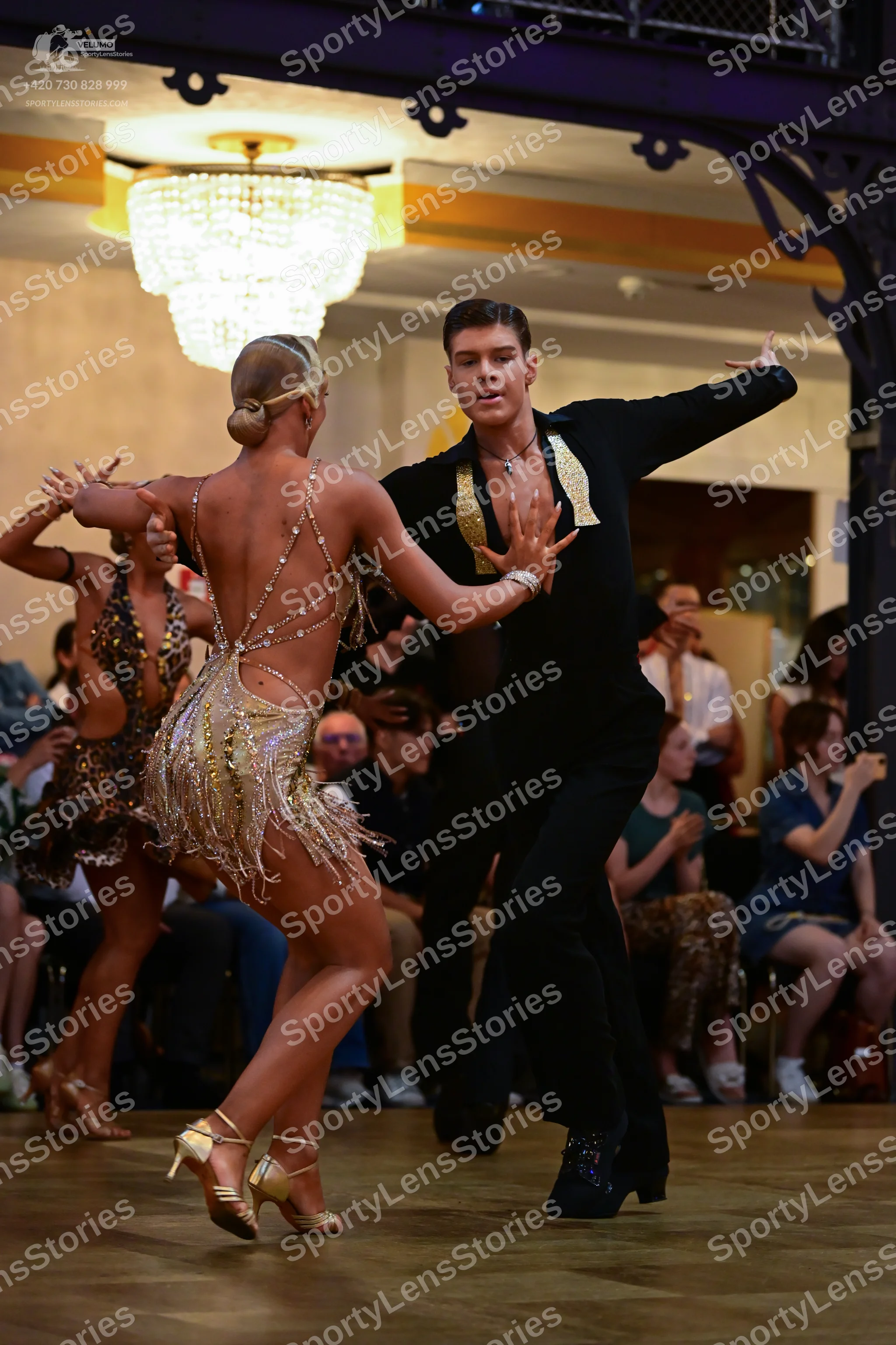 Dancesport competitor: Male dancer: black suit with large gold sequined lapels