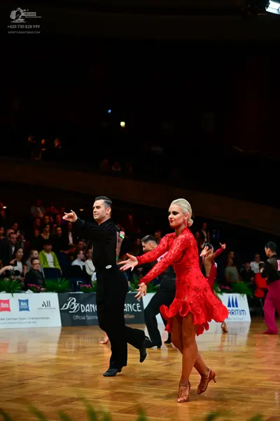 Dancesport competitor: Male dancer: black long-sleeved shirt and black trousers