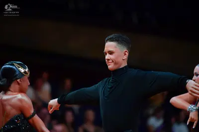 Dancesport competitor: Male dancer: black long-sleeved turtleneck