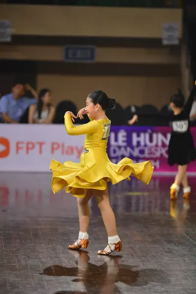 Dancesport competitor #336: Female dancer: yellow latin dress with a voluminous, layered ruffled skirt