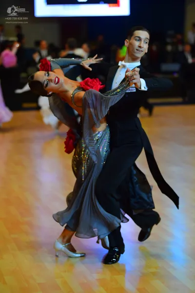 Dancesport competitor: Male dancer: black suit with a white shirt and white bowtie