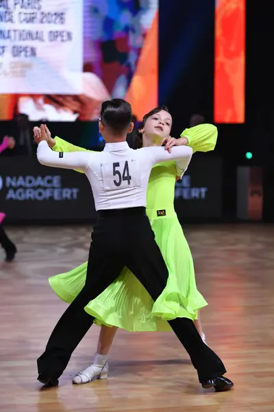 Dancesport competitor: Male dancer: white long-sleeved top and black trousers