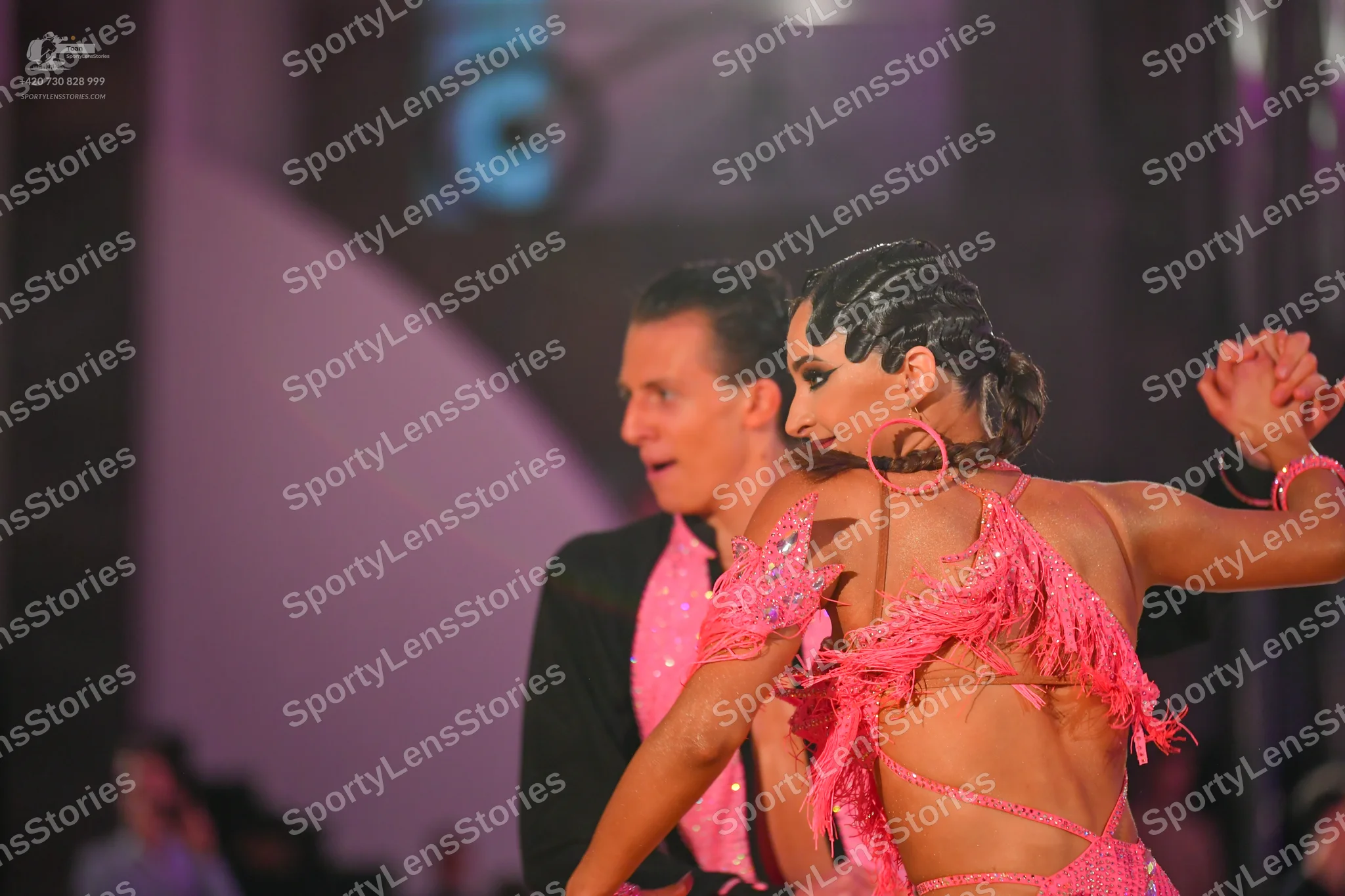 Dancesport competitor: Male dancer: black suit with a bright pink sequined shirt