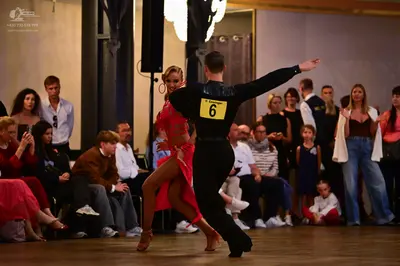 Dancesport competitor: Male dancer: black long-sleeved top and black trousers