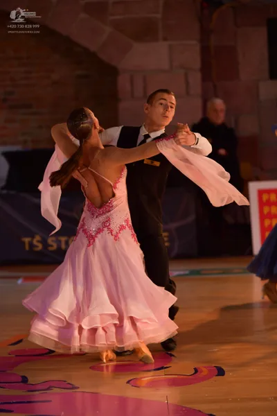 Dancesport competitor: Male dancer: black suit with a white shirt and black tie