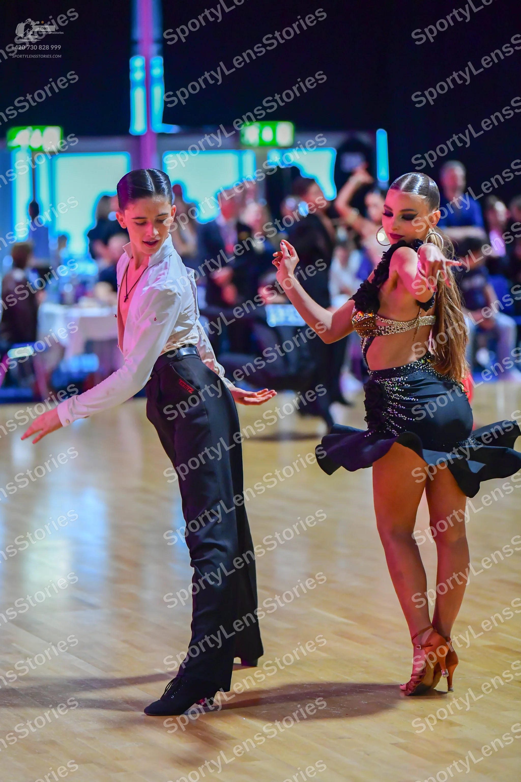 Dancesport competitor: Male dancer: white long-sleeved button-up shirt and black trousers