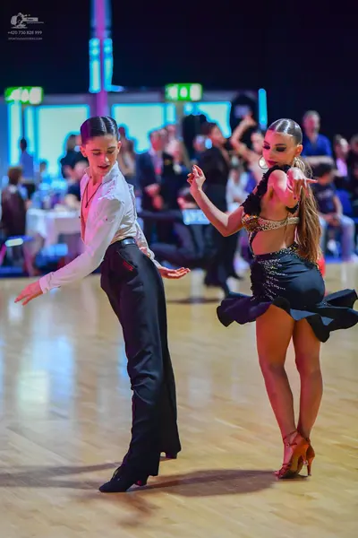 Dancesport competitor: Male dancer: white long-sleeved button-up shirt and black trousers