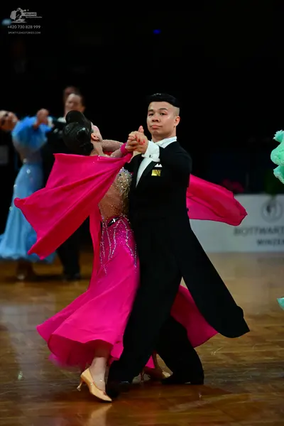 Dancesport competitor: Male dancer: black ballroom suit with a white shirt and white bow tie