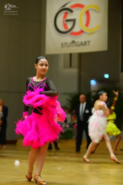 Dancesport competitor: Female dancer: pink latin dress with feathers