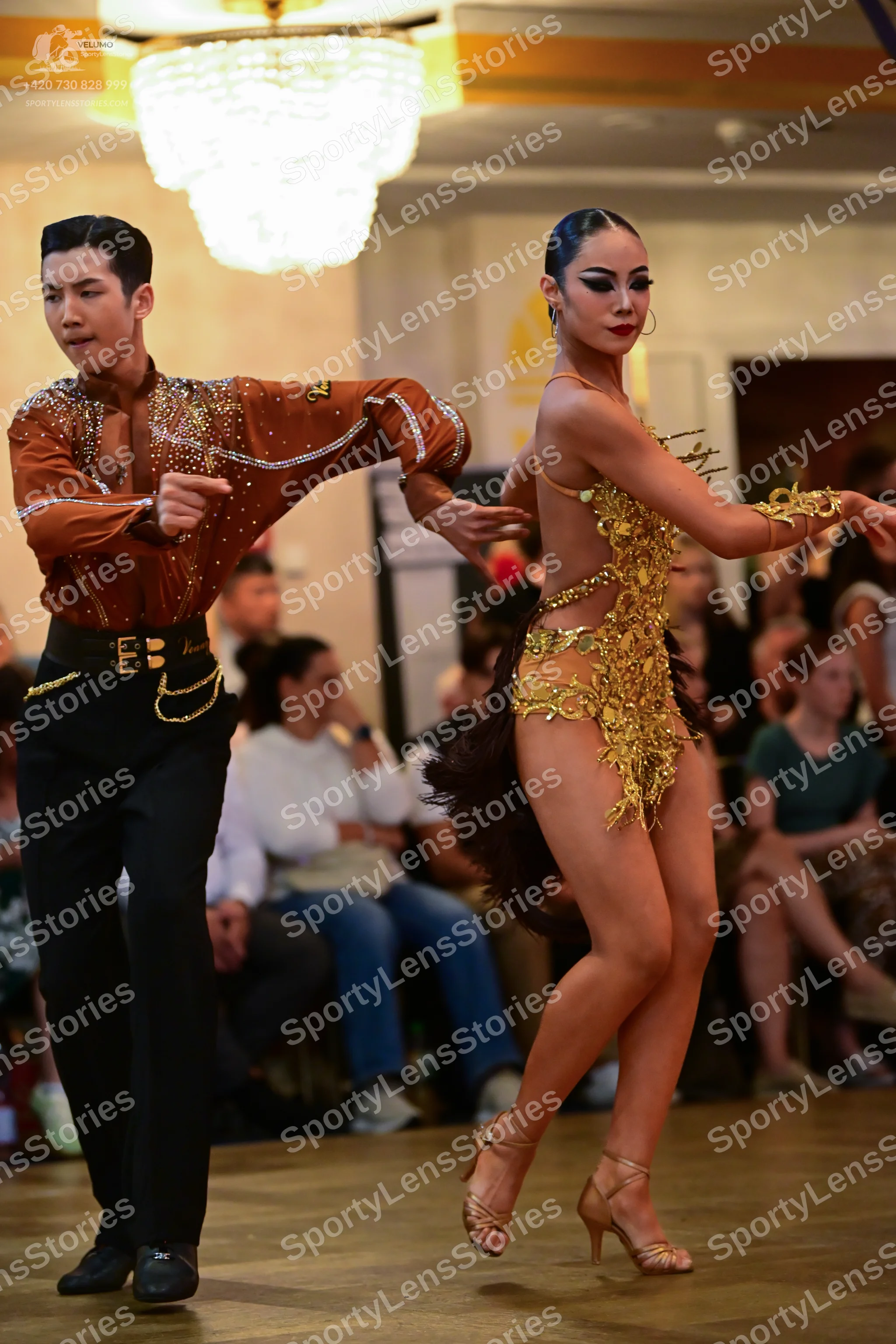 Dancesport competitor: Male dancer: brown long-sleeved shirt with small embellishments, black trousers,