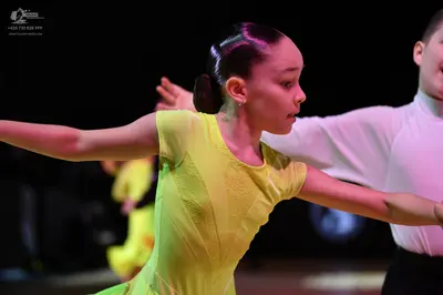 Dancesport competitor: Female dancer: lime green short-sleeved Latin dress