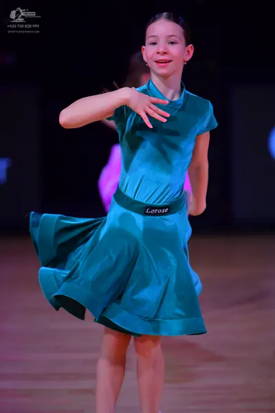 Dancesport competitor: Female dancer: teal satin-like short-sleeved dress with a flared skirt and a wid