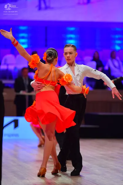 Dancesport competitor: Male dancer: white long-sleeved shirt and black trousers