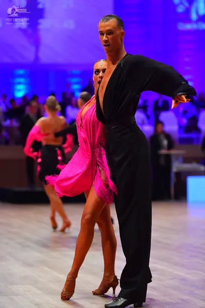 Dancesport competitor: Male dancer: black long-sleeved dance outfit with trousers