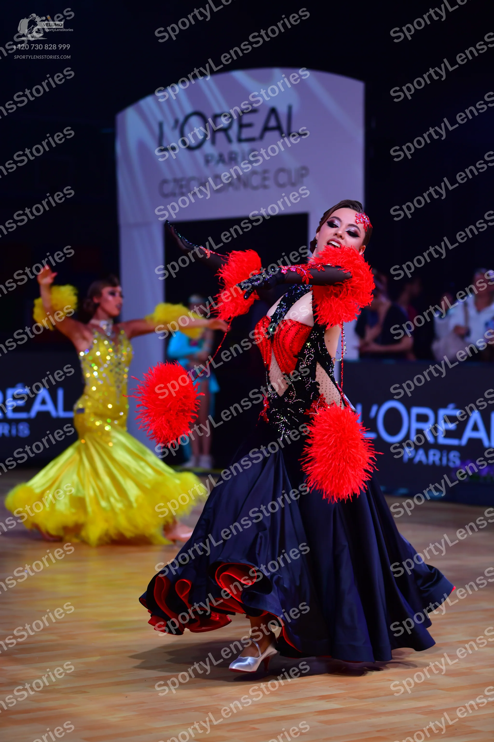 Dancesport competitor: Female dancer 1: yellow sequined latin dress with a voluminous, flowing skirt