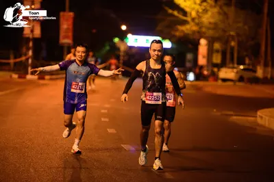 Marathon runner #4221, #4252: Runner 1: blue jersey, blue shorts, white socks, white shoes