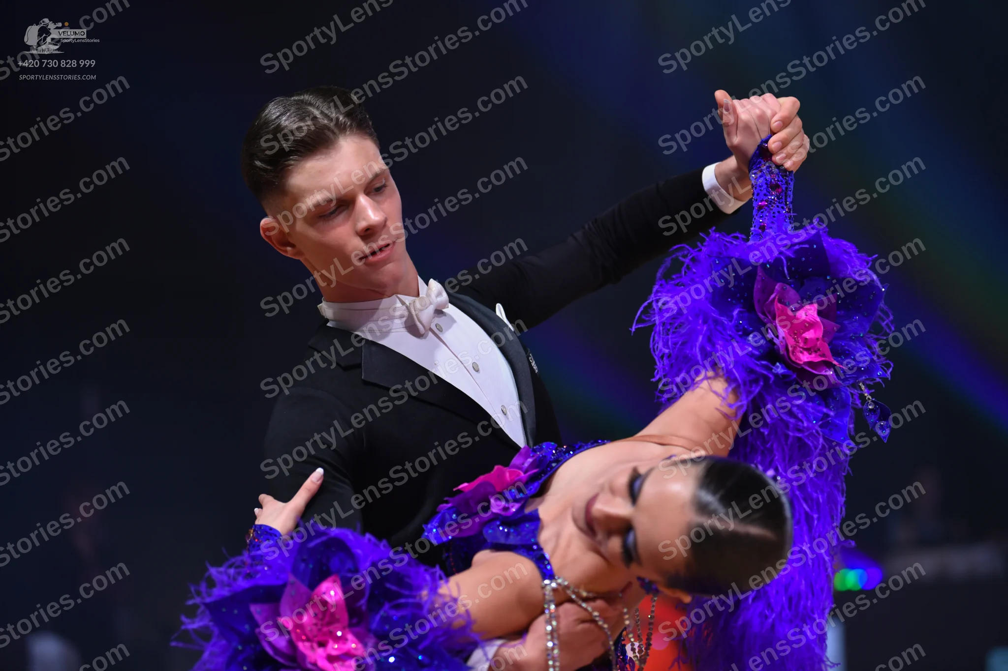 Dancesport competitor: Male dancer: black suit with a white shirt and a white bow tie