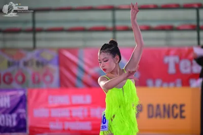 Dancesport competitor: ** Green satin (appears to be a tunic or top) with a slightly flared bottom