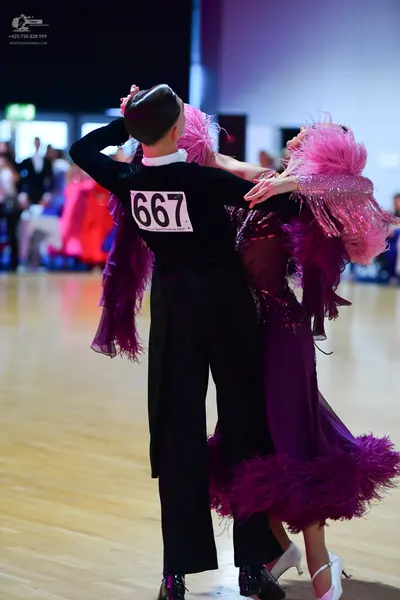 Dancesport competitor #667: Male dancer: black long-sleeved shirt and black trousers
