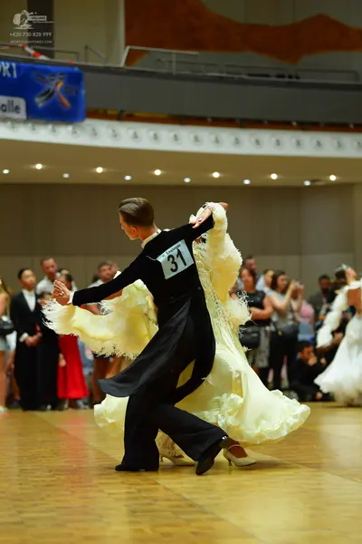 Dancesport competitor: Male dancer: black long-sleeved dance shirt and black trousers