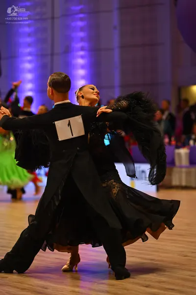 Dancesport competitor: Male dancer: black ballroom suit