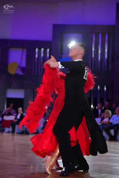 Dancesport competitor: Male dancer: black long-sleeved shirt and black trousers