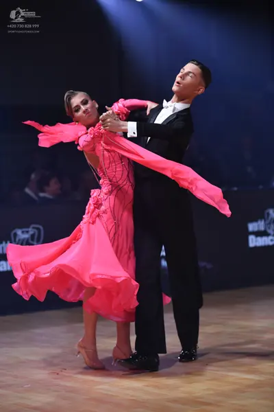 Dancesport competitor: Male dancer: black suit with a white shirt and white bow tie
