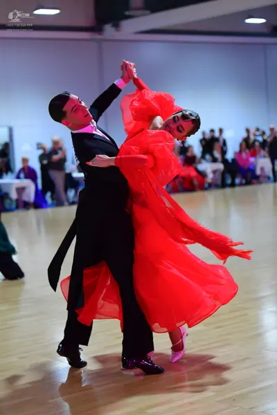 Dancesport competitor: Male dancer: black suit with a white shirt and black tie
