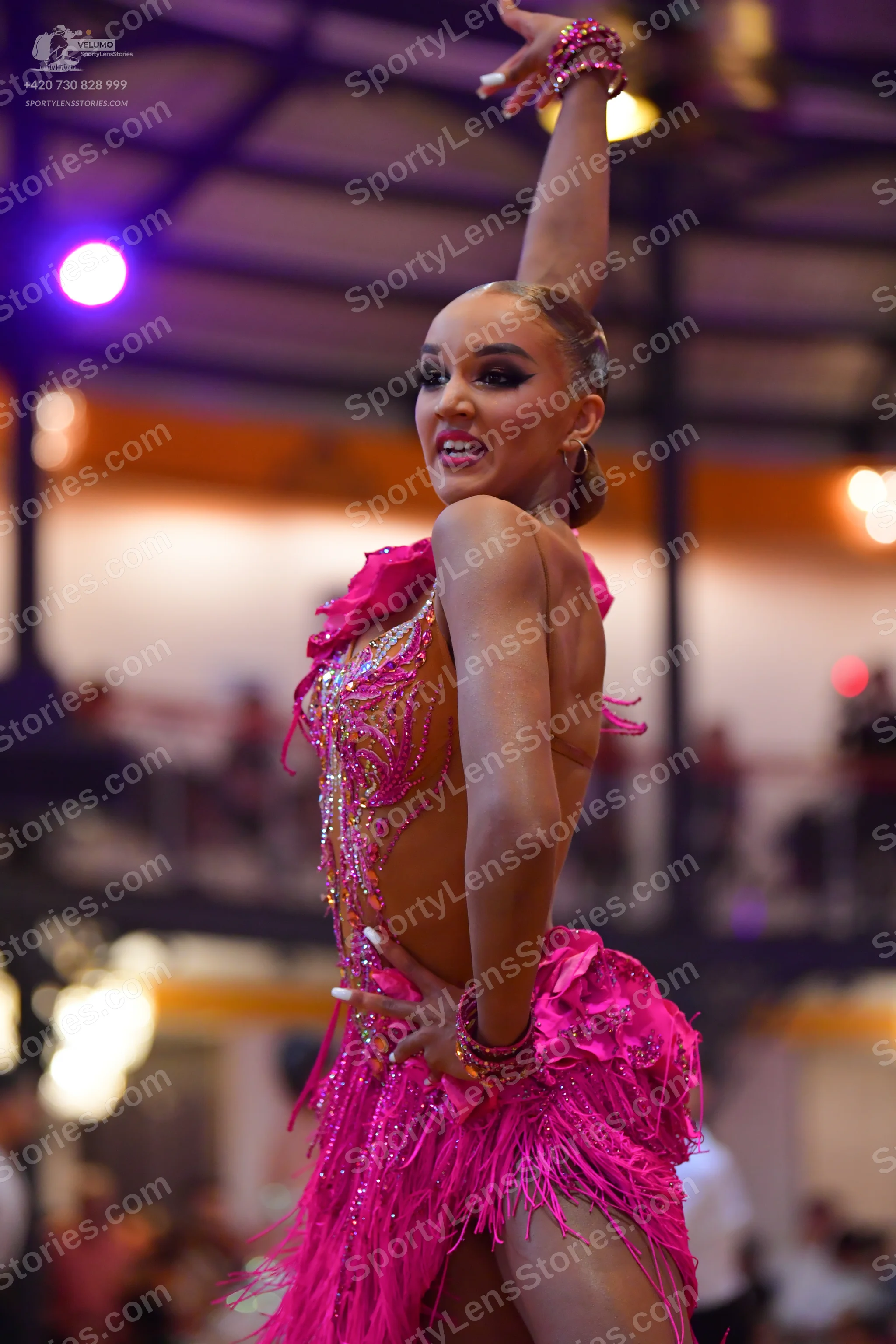 Dancesport competitor: Female dancer: bright pink Latin dress with sequins, beads, and long fringe