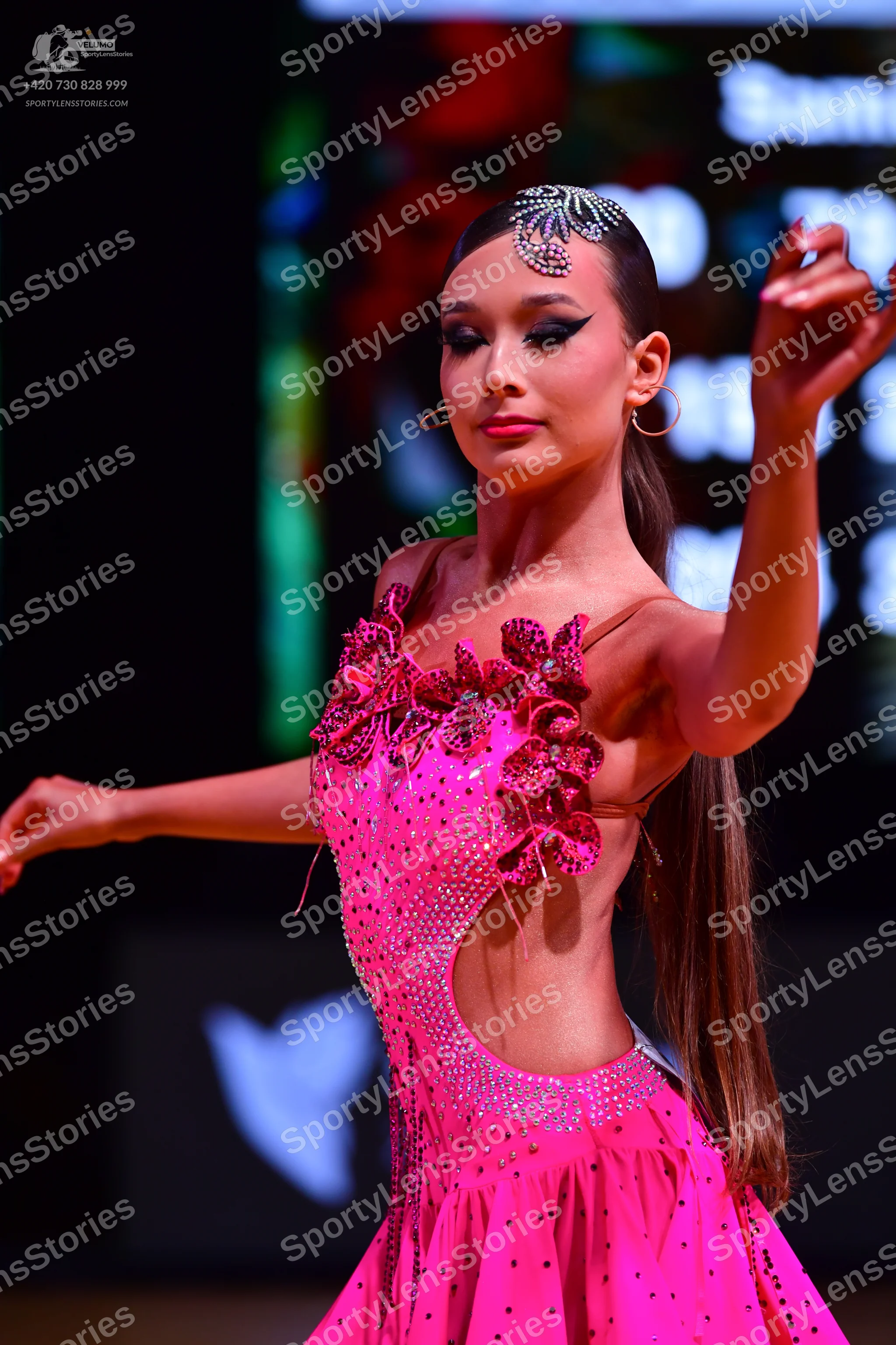Dancesport competitor: Female dancer: bright pink Latin dress with large dark pink floral appliques, rh