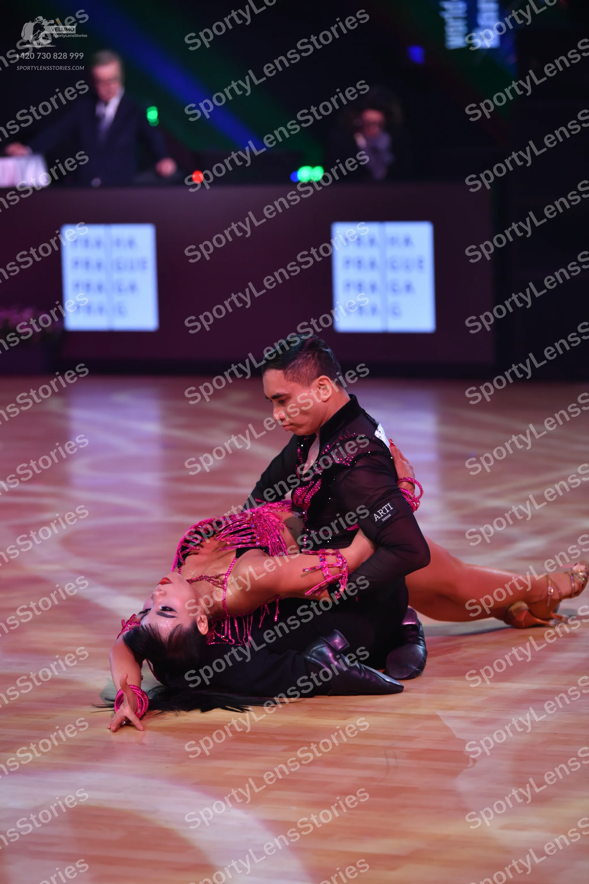 Dancesport competitor: Male dancer: black long-sleeved Latin dance top with sequin details and black tr