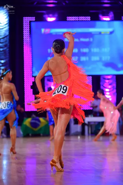 Dancesport competitor #206, #209: Female dancer (center): orange latin dress with long fringe