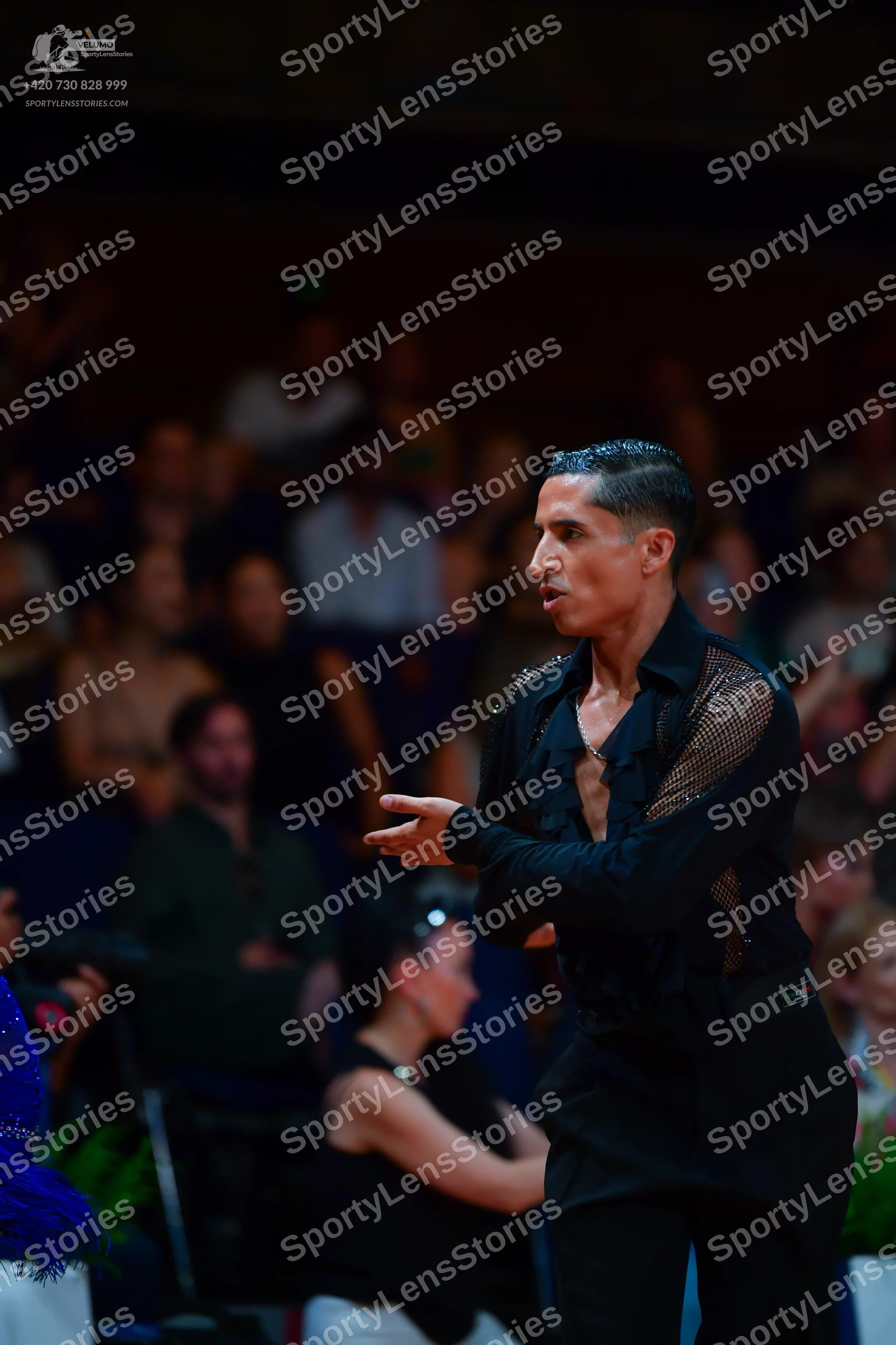 Dancesport competitor: Male dancer: black long-sleeved Latin dance shirt with a sheer mesh panel on the