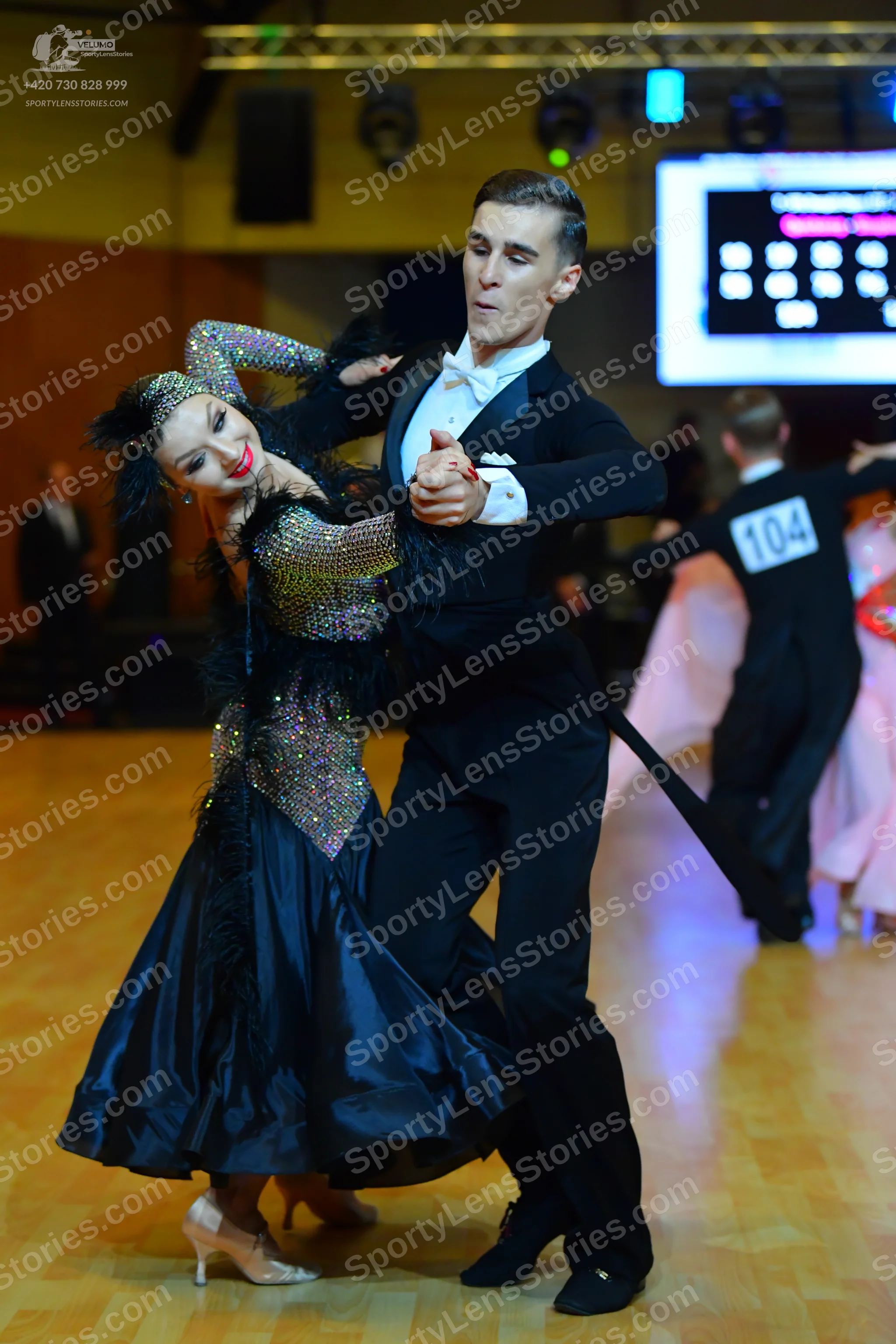 Dancesport competitor #104: Female dancer: dark ballroom dress with a sequined bodice and a full, shiny sati