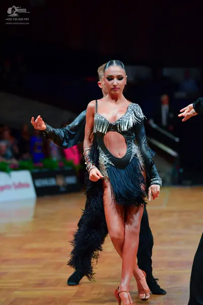 Dancesport competitor: Male dancer: black long-sleeved shirt and black trousers