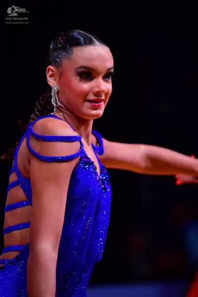 Dancesport competitor: Female dancer: blue sequined latin dress with cutouts