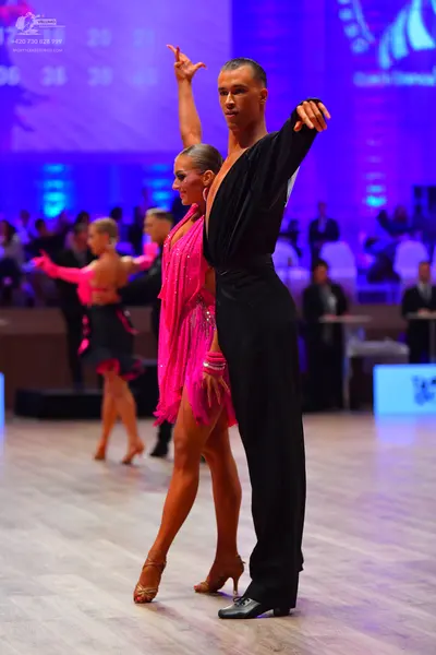 Dancesport competitor: Male dancer: black long-sleeved shirt and black trousers