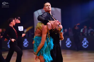 Dancesport competitor: Male dancers: black long-sleeved shirts and black trousers