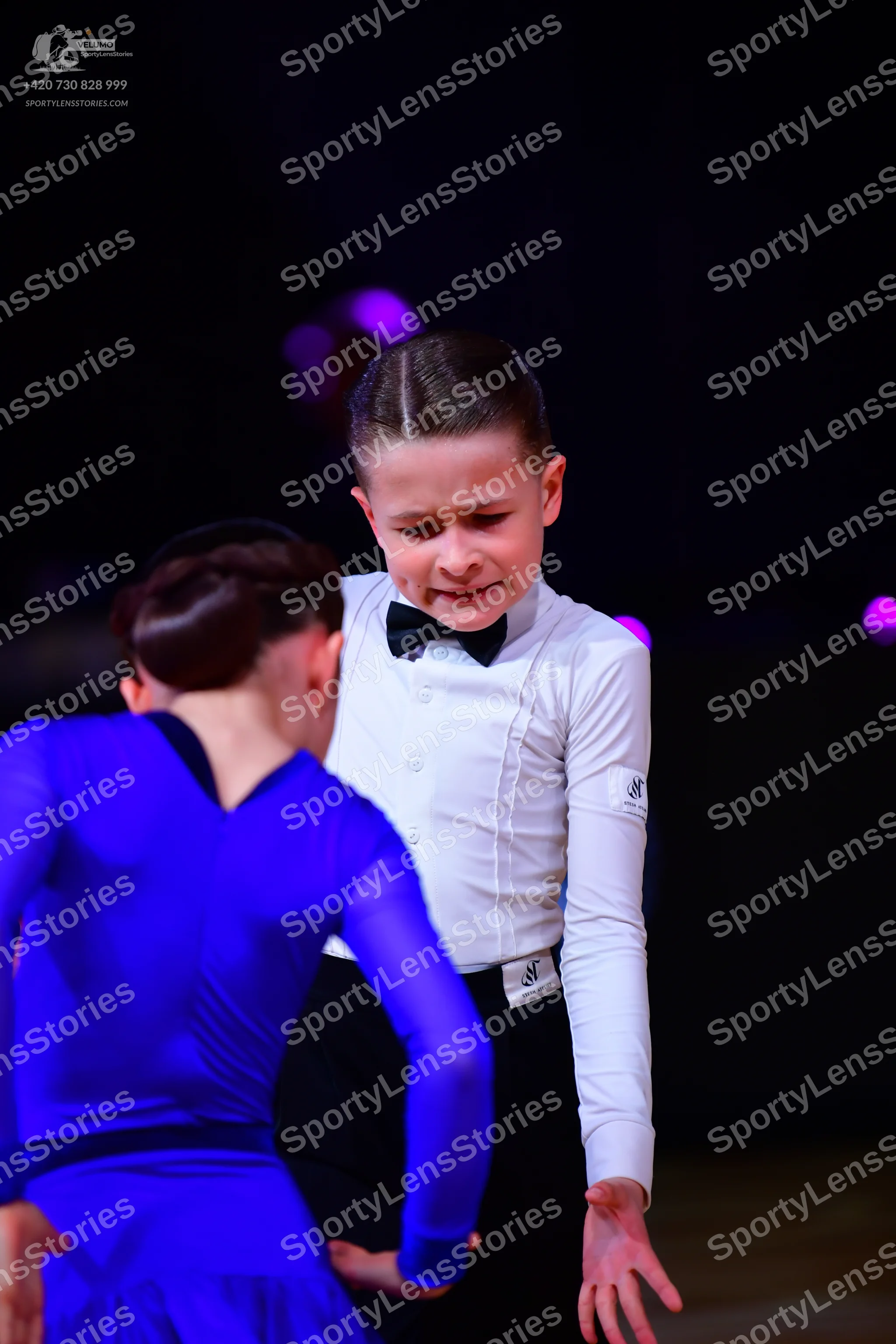 Dancesport competitor: Male dancer: white long-sleeved shirt with a black bow tie and black trousers