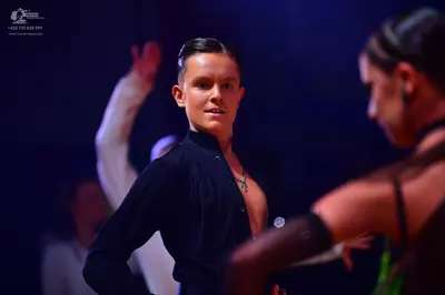 Dancesport competitor: Male dancer: black long-sleeved fitted dance top