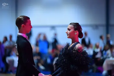 Dancesport competitor: Male dancer: black suit with a white shirt