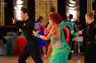 Dancesport competitor: Male dancer (left): black long-sleeved shirt and black trousers