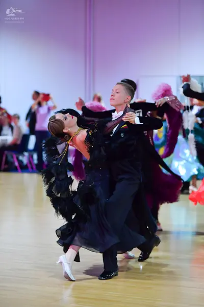 Dancesport competitor: Male dancer: black suit with a white shirt and black bow tie