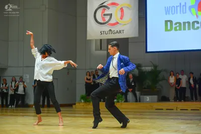 Dancesport competitor: Female dancer: white long-sleeve shirt and black pants