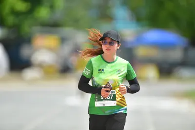 Marathon runner #5767: Runner 1: green jersey with yellow pattern, black long-sleeved undershirt, black