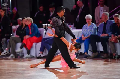 Dancesport competitor: Male dancer: black long-sleeved Latin dance shirt with subtle pattern on shoulde