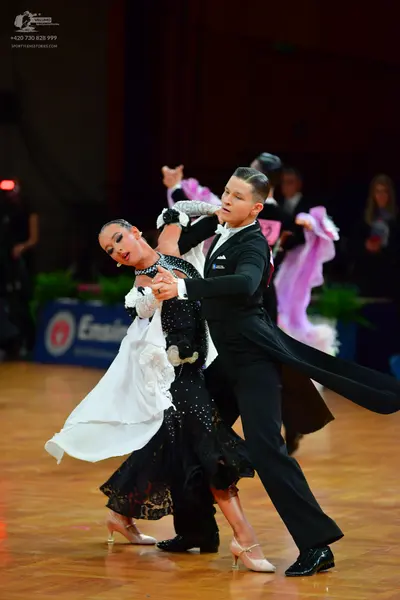 Dancesport competitor: Male dancer: black tailcoat, black trousers, and black dance shoes